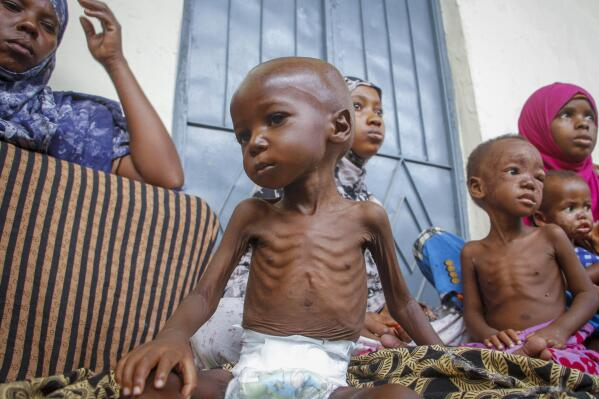 Children smiling in a community supported by the NGO